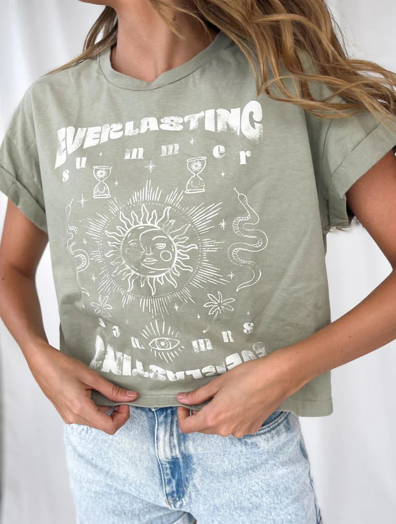 stitched cuffed sleeves and a buttery soft feel. the sun and moon graphic is all in white. The writing says everlasting summer